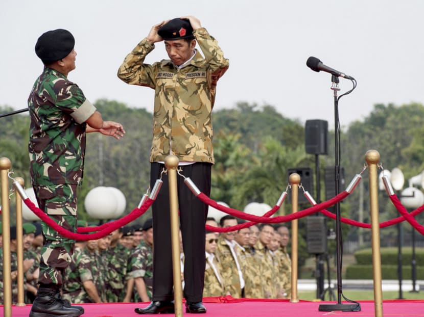 Indonesian President Joko Widodo (right) being appointed an honorary member of the Special Forces by Commander General Moeldoko in Jakarta on Thursday. 
Mr Widodo feels Bandung is 95 per cent ready for the event. PHOTO: REUTERS