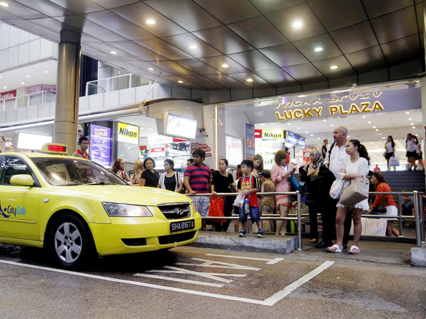 A queue for taxis in front of Lucky Plaza. Those who line up for cabs in Orchard could save time and money by combining two modes of transport. TODAY file photo