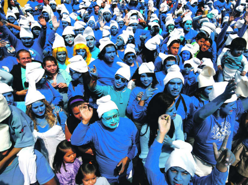 People dressed as Smurfs taking part in a Global Guinness World Record attempt for the most people dressed as Smurfs. Photo: Reuters