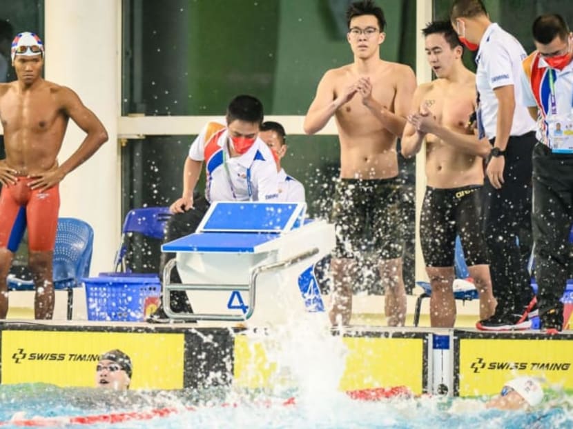 Singapore's 4x100 freestyle relay team reacts after winning their race. They were later disqualified.