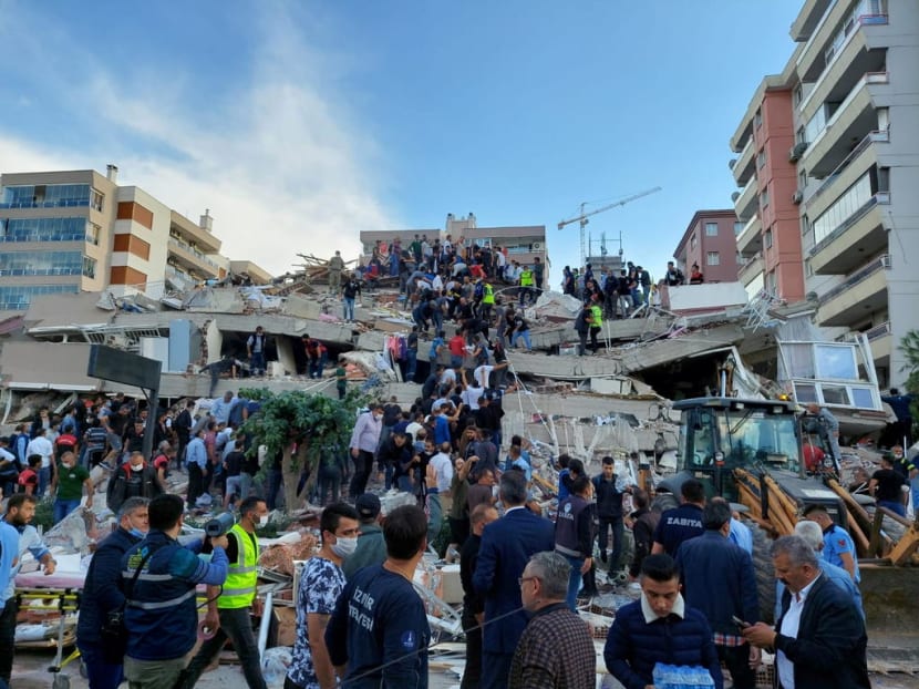 Locals and officials search for survivors at a collapsed building in Izmir.