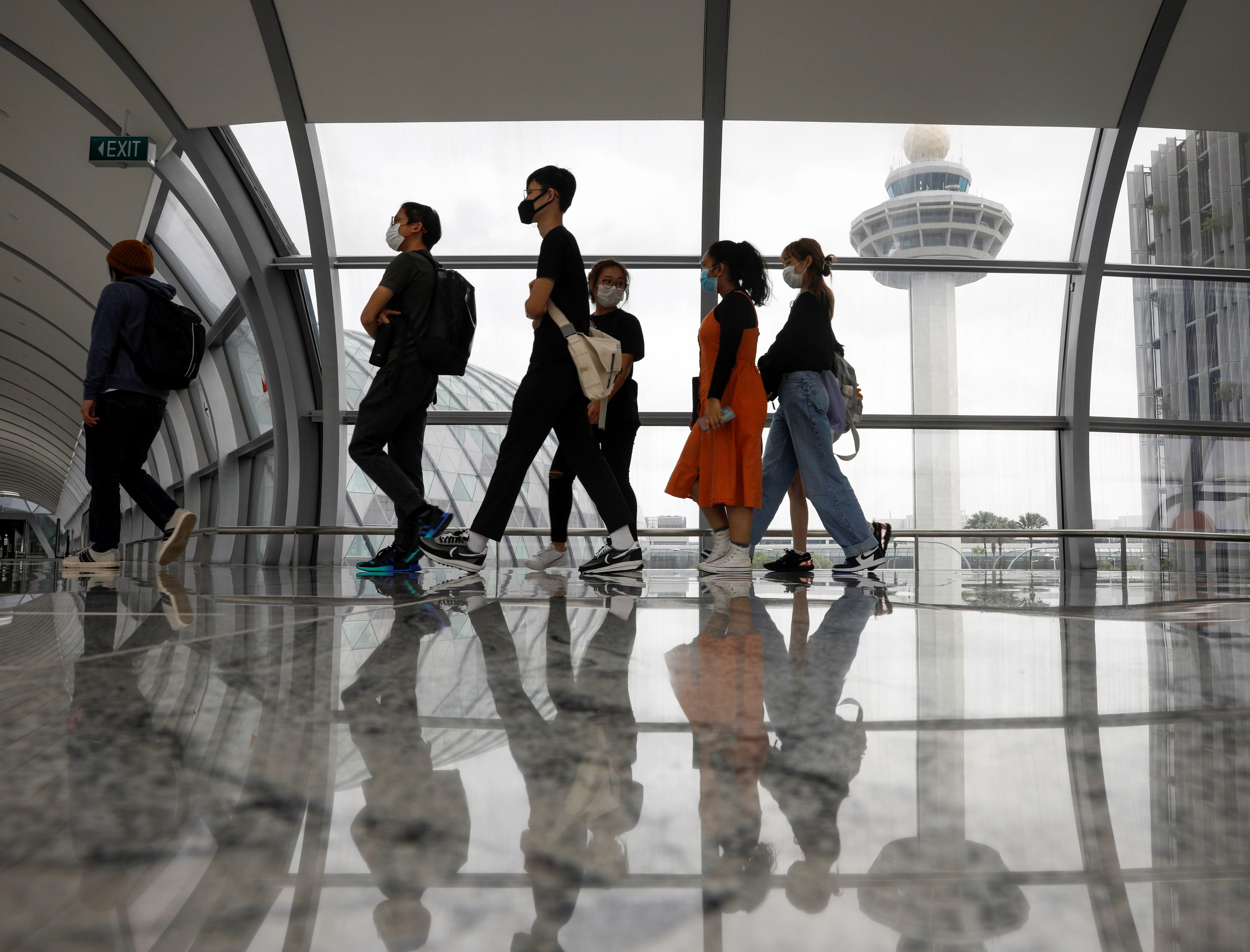 People passing the control tower of Changi Airport. People passing the control tower of Changi Airport.