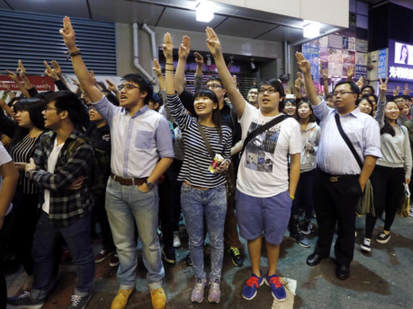 Hong Kong protesters imitating a three-finger salute from The Hunger Games movie in Mong Kok on Thursday. Protest leaders want any election committee to accept the candidates chosen by voters. Photo: Reuters