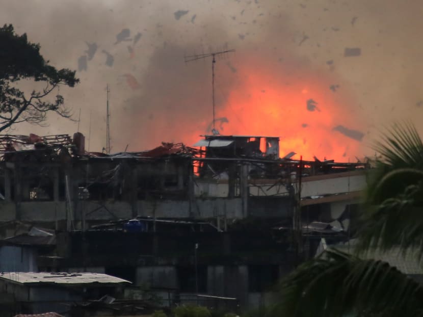 Debris and fire is seen after an OV-10 Bronco aircraft released a bomb, during an airstrike, as government forces continue their assault against insurgents from the Maute group, who have taken over large parts of Marawi City, Philippines June 19, 2017. Photo: Reuters