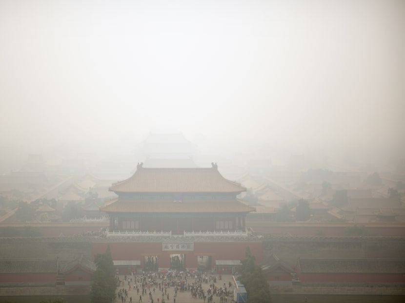 Haze envelops the Forbidden City as seen from nearby hilltop park on a polluted day in Beijing on Oct 7, 2015. Photo: AP