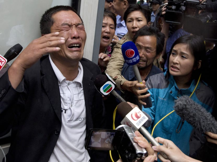 Ji Zhongji cries as he speaks to journalists about his brother Ji Zhongxing, who is on trial for endangering public safety by setting off an explosion two months ago at Beijing's airport, outside a courthouse in Beijing, China, Tuesday, Sept. 17, 2013. Photo: AP
