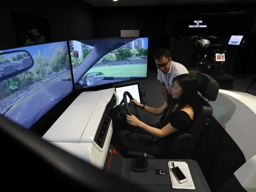 The author at the wheel of the simulator as senior driving instructor Don Tang looks on.