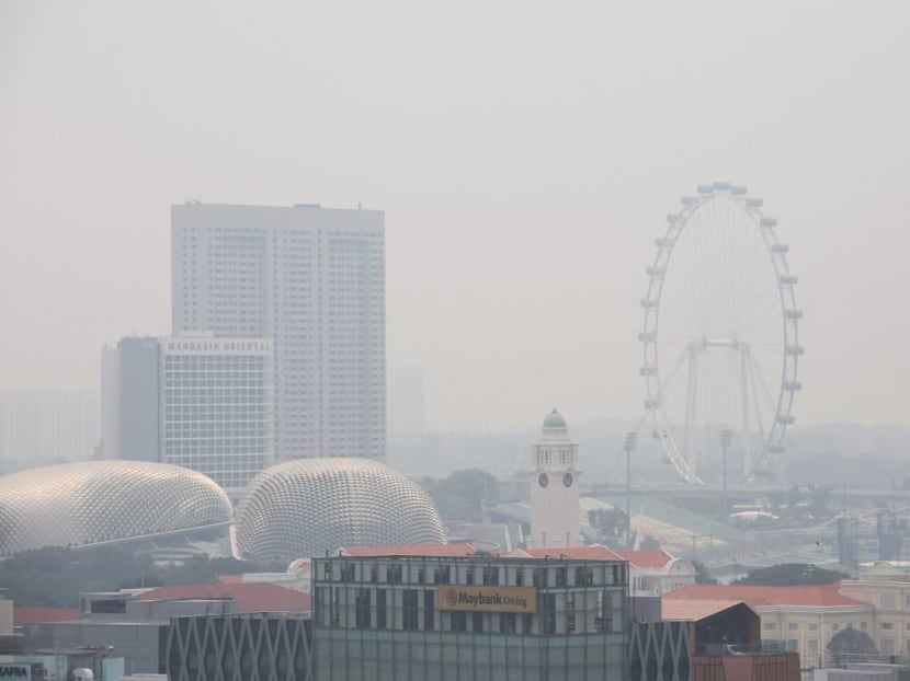 The scene downtown about noon on Friday (Sept 13). The National Environment Agency (NEA) said slightly hazy conditions were persisting in Singapore as prevailing winds blew smoke haze in from Sumatra.