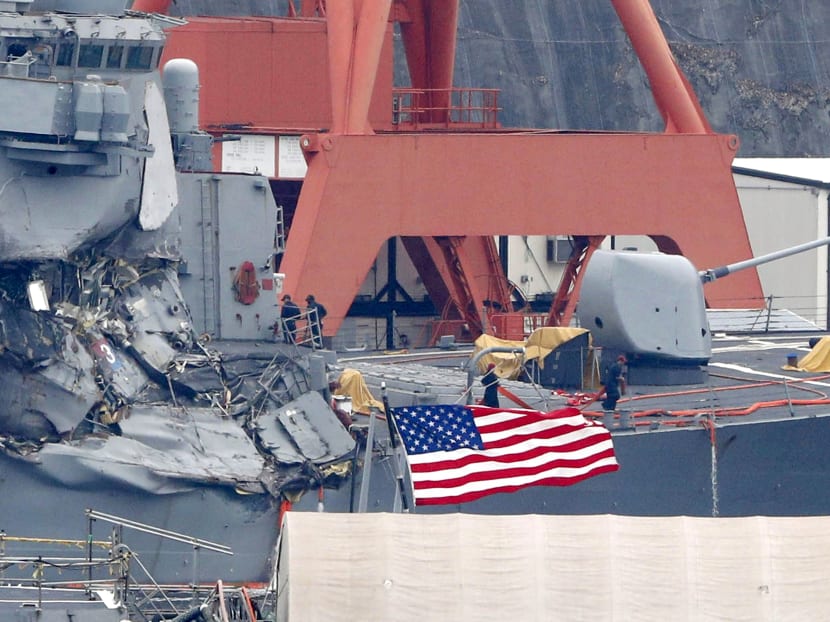 The damaged USS Fitzgerald is seen at Yokosuka Naval Base, south of Tokyo on Sunday, June 18, 2017.  US Navy divers found the bodies of missing sailors aboard the stricken destroyer, which had collided with a container ship on Saturday in the busy sea off Japan. Photo: Kyodo News via AP