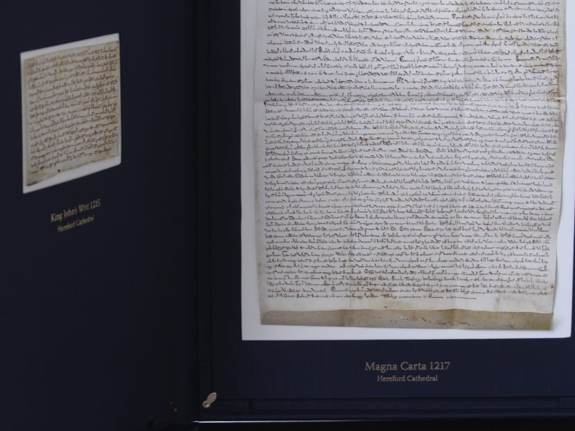 A replica of the 1217 Magna Carta (right) with a copy of the 1215 King's Writ (left) from the Hereford Cathedral. The actual documents will be on public display at the Supreme Court from Nov 19-23. Photo: Daryl Kang/TODAY