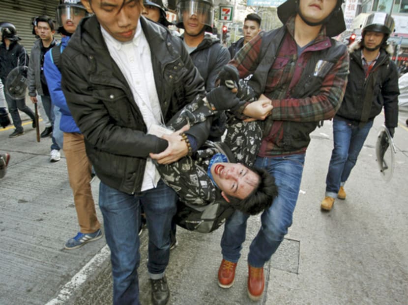 A protester shouts as he is arrested by plainclothes policemen after a clash in Mong Kok district in Hong Kong on Feb 9. PHOTO: REUTERS