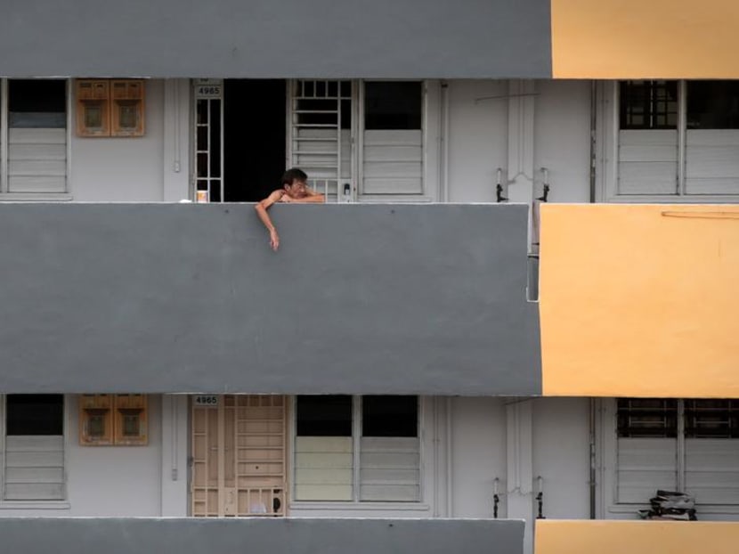 A resident at the common corridor of a two-room rental flat block along Ang Mo Kio Ave 6.