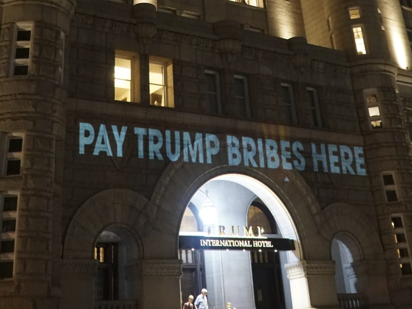 ‘Pay Trump bribes here’ projected on Trump hotel in Washington