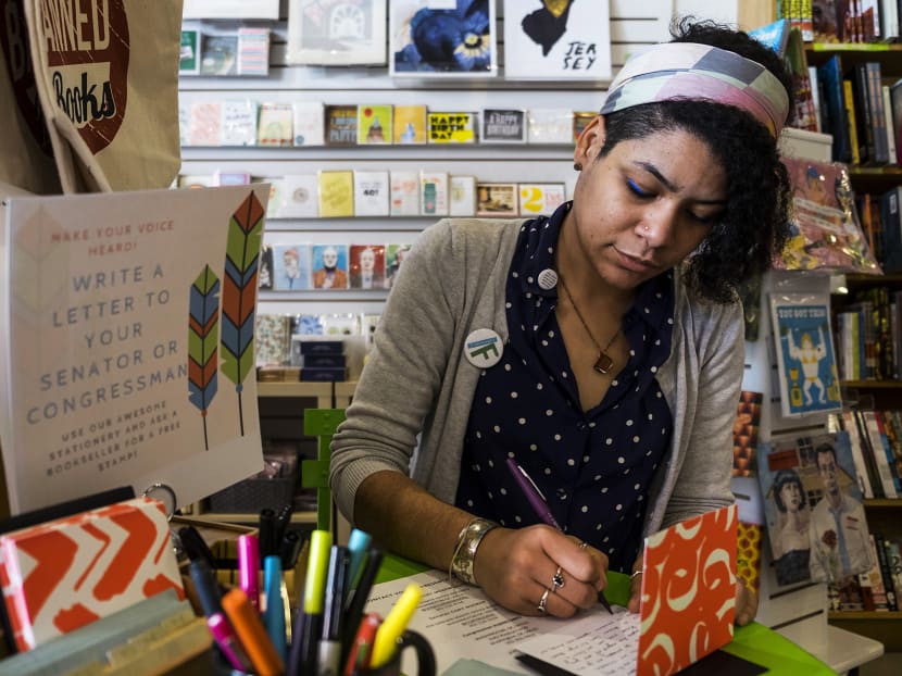 Ms Hannah Oliver Depp, the manager of Word bookstore, writes a letter to Sen. Cory Booker thanking him for his resistance against the Trump administration, in Jersey City, on Feb 2, 2017. Independent shops have become magnets for a growing movement, with some taking a protest role beyond deciding what titles to display.  Photo: New York Times