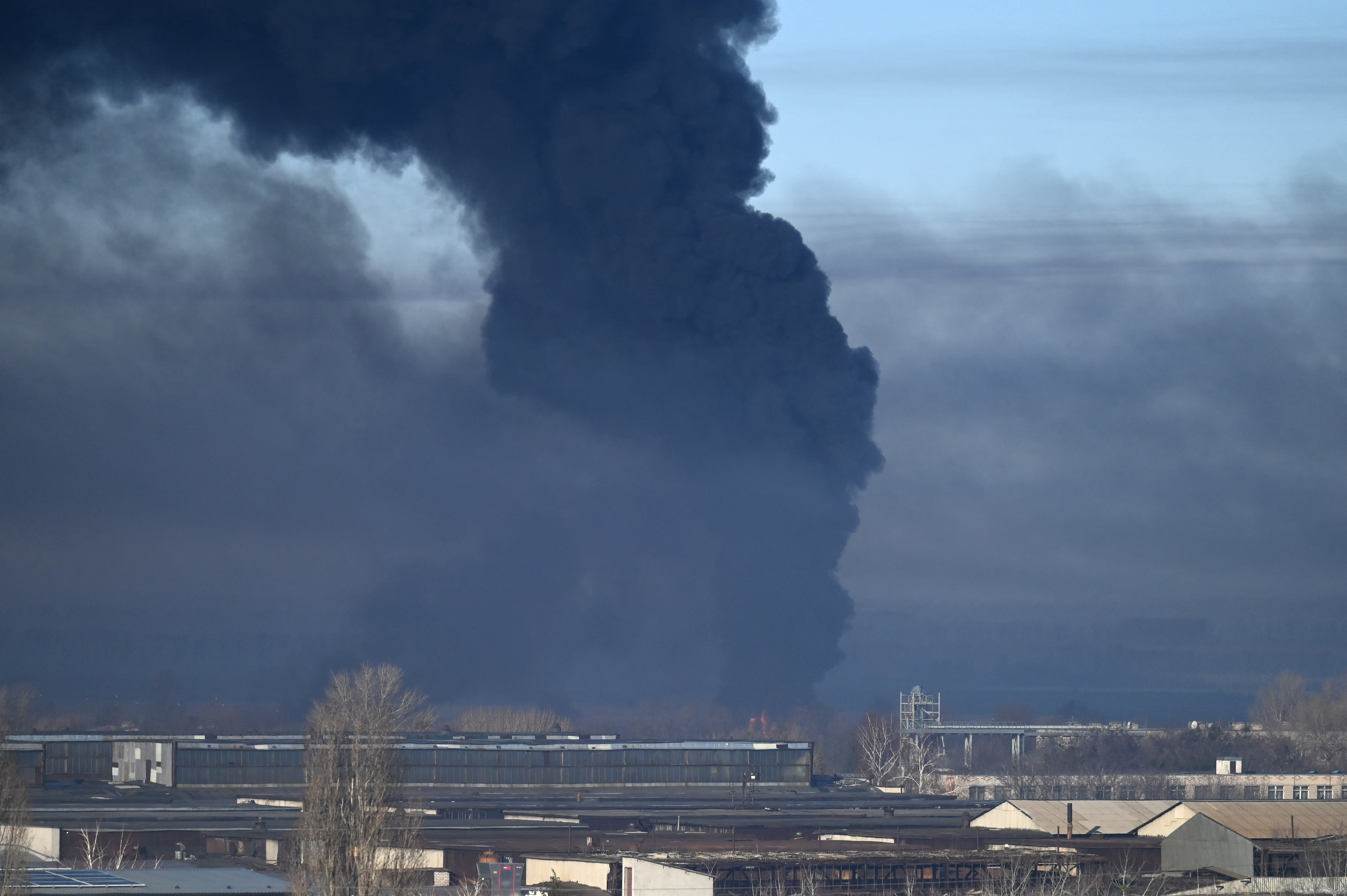 Black smoke rises from a military airport in Chuguyev near Kharkiv on Feb 24, 2022