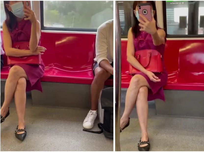 A woman in a pink dress is captured in a viral video on social media pointing her phone at other commuters on an MRT train and making racist remarks. A woman in a pink dress is captured in a viral video on social media pointing her phone at other commuters on an MRT train and making racist remarks.