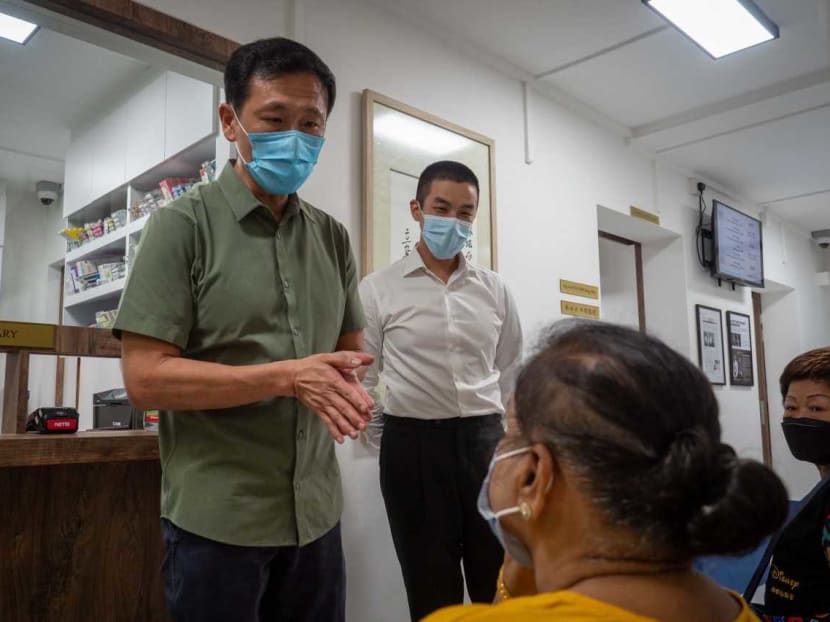 Dr Lim Hong Shen (right) from A Medical Clinic in Everton Park near Tanjong Pagar looking on as Health Minister Ong Ye Kung (left) visited the clinic.