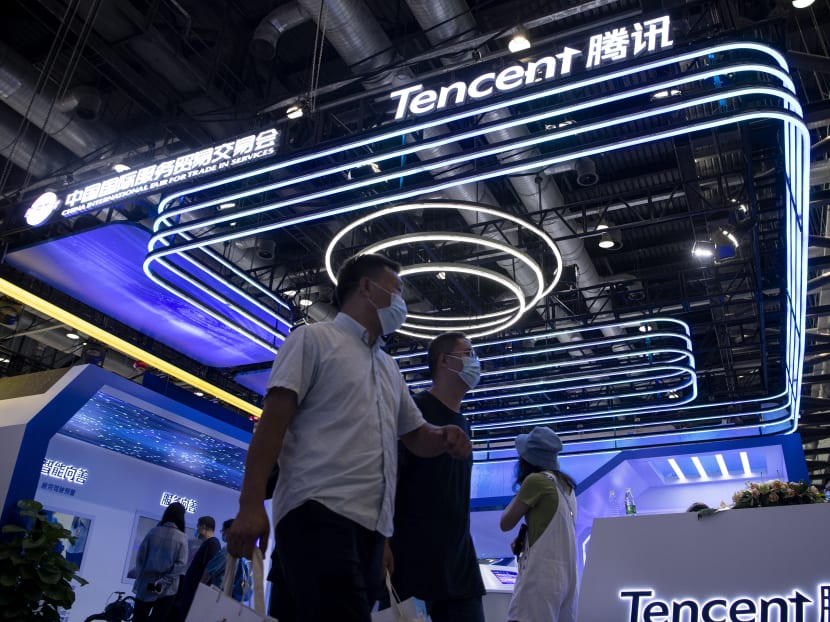 People walk past the Tencent booth at the China International Fair for Trade in Services in Beijing, China on Sept 6, 2020.