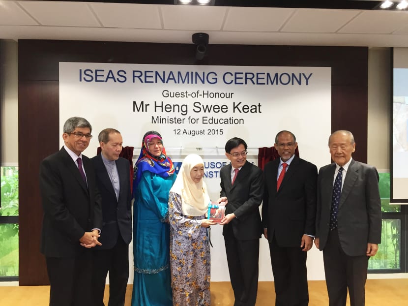 Education Minister Heng Swee Keat presents Puan Noor Aishah with a copy of a new book on her husband, Singapore's first president Yusof Ishak, at the renaming ceremony for the ISEAS - Yusof Ishak Institute. Photo: Valerie Koh