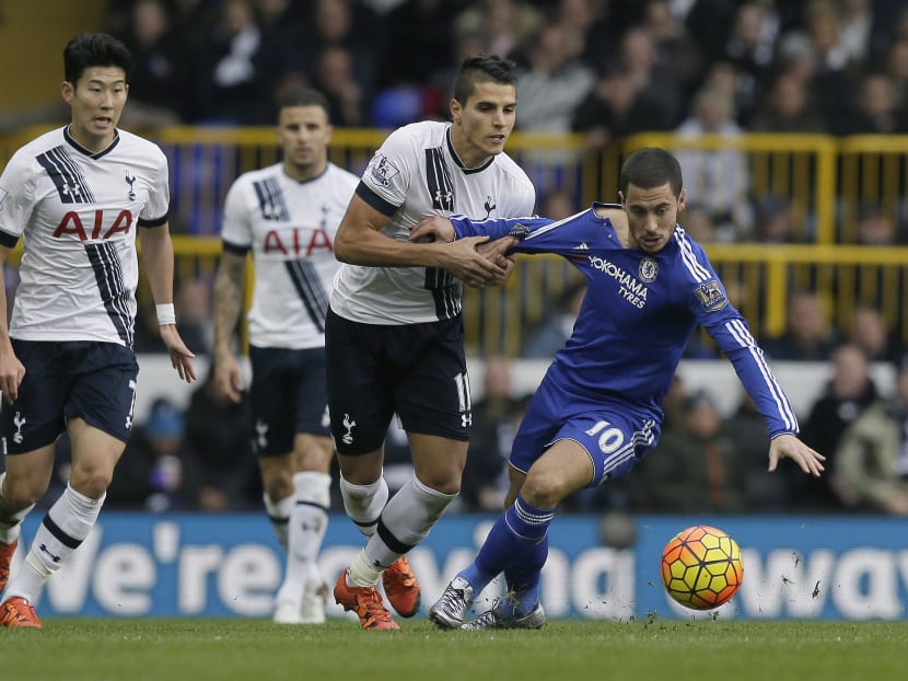 Chelsea’s Eden Hazard, right, competes for the ball with Tottenham’s Erik Lamela during the English Premier League soccer match between Tottenham Hotspur and Chelsea at White Hart Lane in London on Nov 29, 2015. Photo: AP