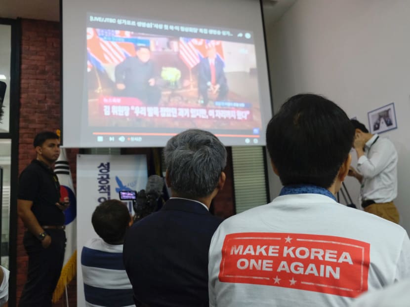 South Koreans watch a live stream of the historic meeting between US President Donald Trump and North Korean leader Kim Jong-un at the Korean Association in Singapore, June 12, 2018. Photo: Chng Shao Kai/TODAY
