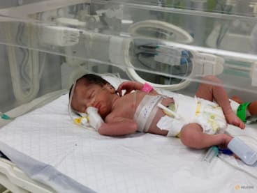 A Palestinian baby girl, saved from the womb of her mother Sabreen Al-Sheikh (Al-Sakani), who was killed in an Israeli strike along with her husband Shokri and her daughter Malak, lies in an incubator at Al-Emirati hospital in Rafah in the southern Gaza Strip on April 21, 2024.