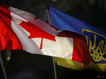FILE PHOTO: A Canadian flag and a Ukrainian flag with the tryzub are seen during a rally to mark the one year anniversary of Russia’s invasion of Ukraine at the Canadian Museum for Human Rights in Winnipeg, Manitoba, Canada on February 24, 2023.  REUTERS/Shannon VanRaes