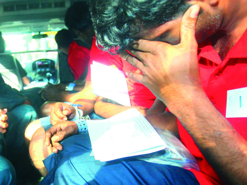 Some of the 24 suspects arriving at the Subordinate Courts in police vans yesterday. Photo: Ernest Chua