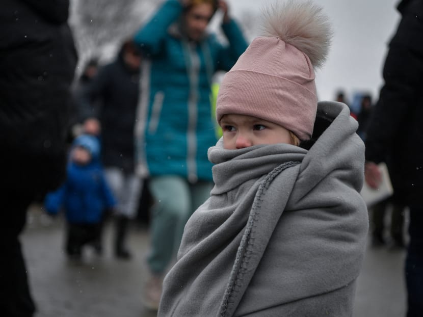A child is wrapped in a blanket as Ukrainian refugees cross the border into Poland on March 9, 2022.