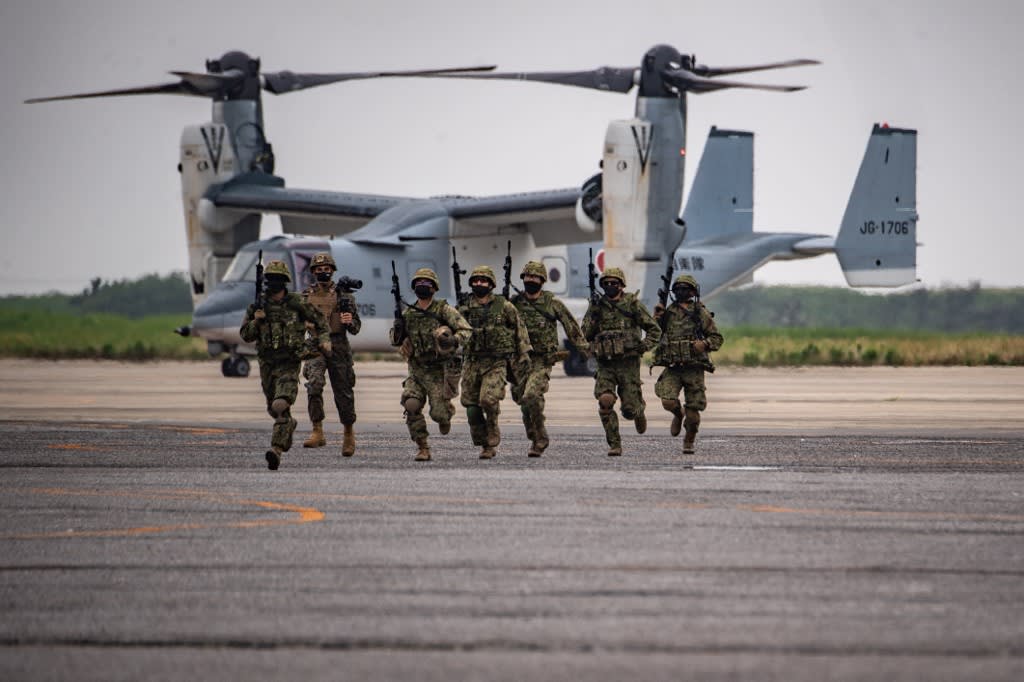 Members of the Japan Ground Self-Defense Force take part in a military display in front of a V-22 Osprey at the Japan Ground Self-Defense Force's Camp Kisarazu in Chiba prefecture on June 16, 2022. Members of the Japan Ground Self-Defense Force take part in a military display in front of a V-22 Osprey at the Japan Ground Self-Defense Force's Camp Kisarazu in Chiba prefecture on June 16, 2022.