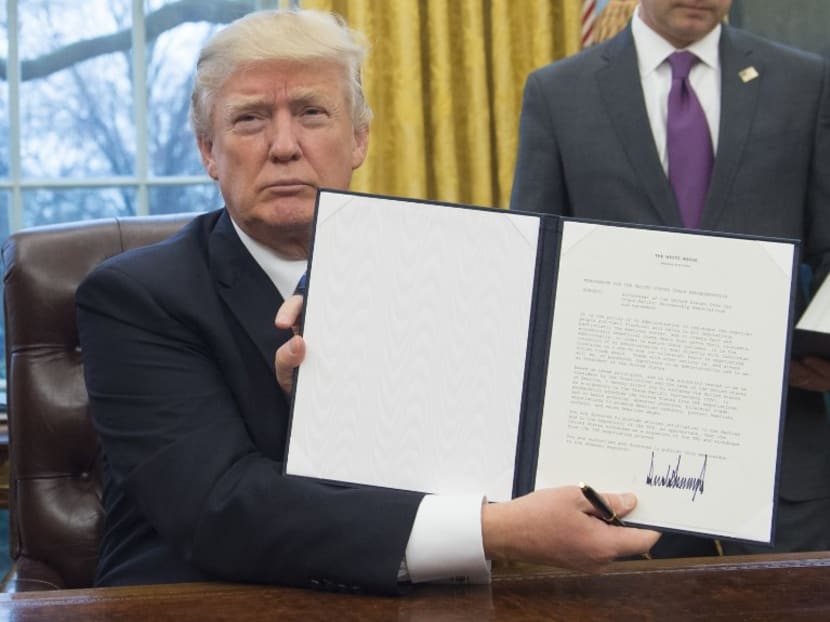 United States President Donald Trump holding up the executive order withdrawing the US from the Trans-Pacific Partnership. Photo: AFP
