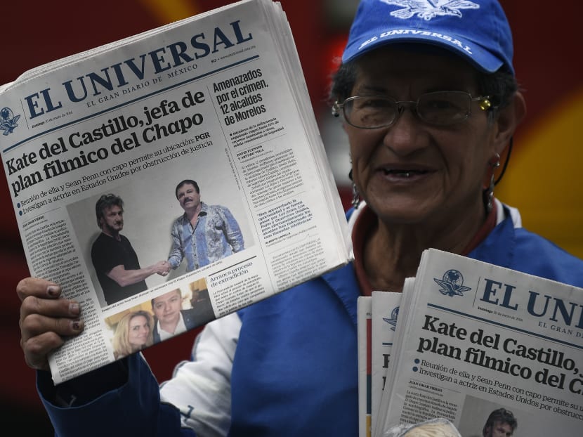 A Mexican vendor sells newspapers showing a picture of drug lord Joaquin Guzman shaking hands with American actor Sean Penn. Photo: AFP