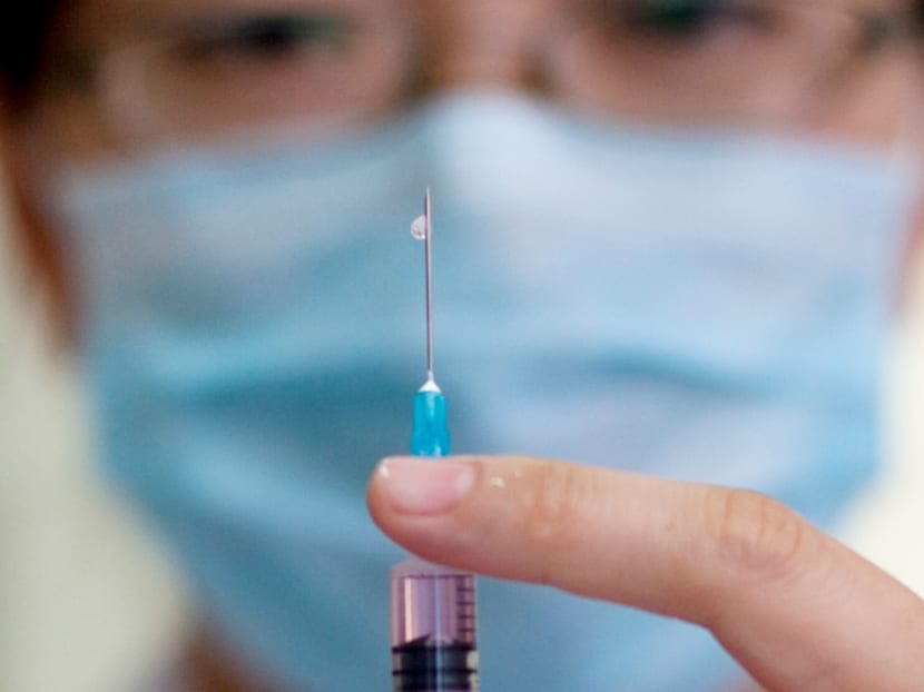 A nurse prepares a vaccine shot against measles. AP file photo