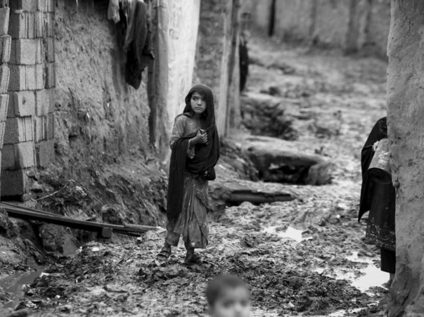 A girl walking in a muddy alley on her way home in a slum area on the outskirts of Islamabad. Pakistan’s per capita income has increased only three-fold since 1950. Photo: REUTERS