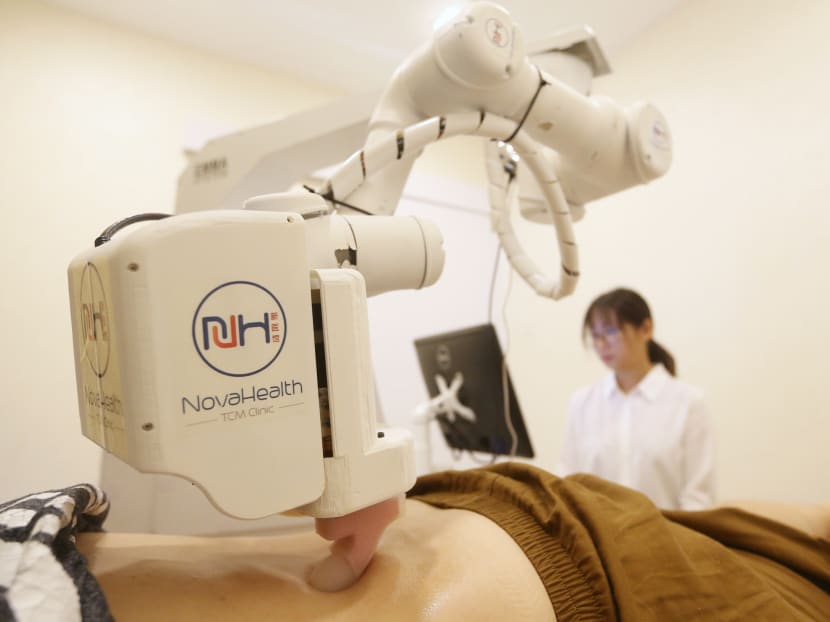 Singapore’s first robot masseur Emma specialises in back and knee massages, at a massage demonstration during its official launch at NovaHealth TCM clinic, Raffles Place. Photo: Koh Mui Fong/TODAY