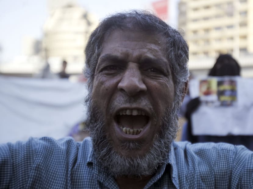 A supporter of the Muslim Brotherhood and ousted Egyptian President Mohamed Mursi shouts slogans against the military and interior ministry during a protest in front of Al Istkama mosque at Giza Square, south of Cairo, August 18, 2013. Photo: Reuters