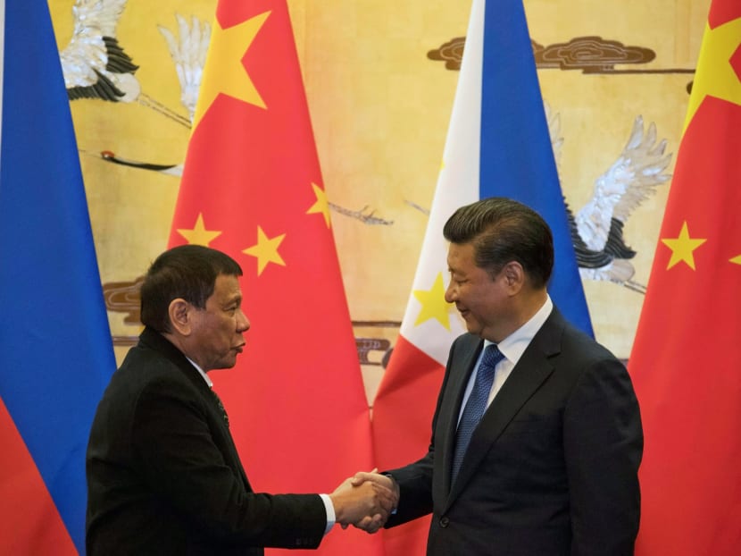 Philippines President Rodrigo Duterte (L) and Chinese President Xi Jinping shake hands after a signing ceremony held in Beijing, China.
