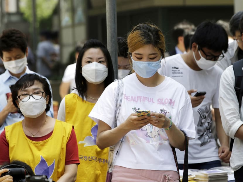 South Koreans wearing masks as a precaution against MERS in Seoul yesterday. The country’s missteps in controlling MERS are in stark contrast to its effectiveness in managing the SARS outbreak in 2003. Photo: AP