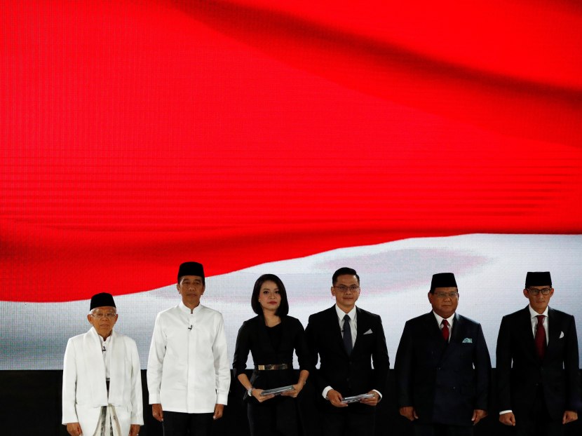 Indonesia's President Joko Widodo, his running mate Ma'ruf Amin, presidential candidate Prabowo Subianto and his running mate Sandiago Uno sing the national anthem before their last presidential debate in Jakarta, Indonesia April 13, 2019.