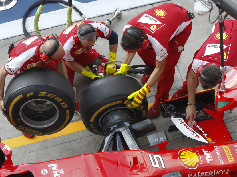 Ferrari technicians testing a pit stop at the Monza racetrack in Italy on Thursday. Pirelli has blamed debris on the track and prolonged usage for tyre cuts in Belgium. Photo: AP