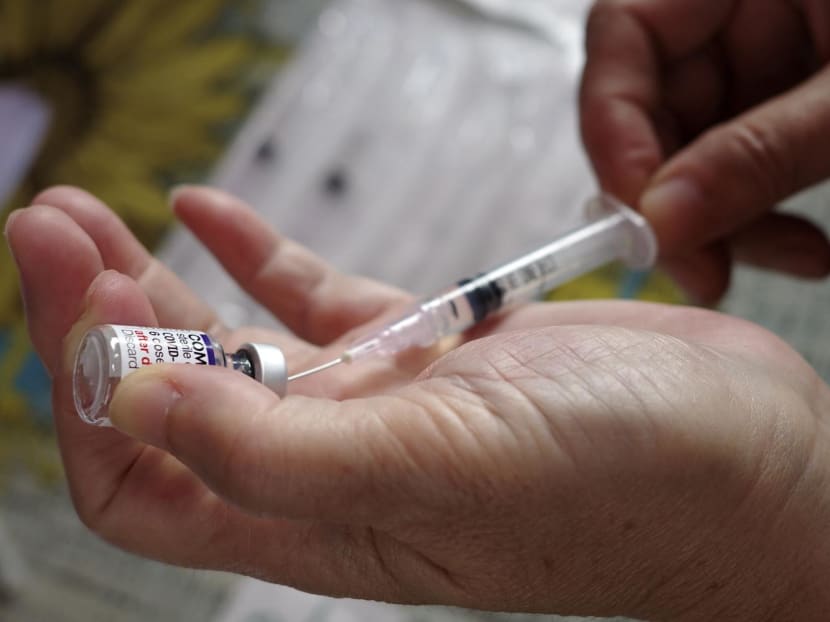 A health worker prepares a dose of Pfizer Covid-19 coronavirus vaccine at a health centre