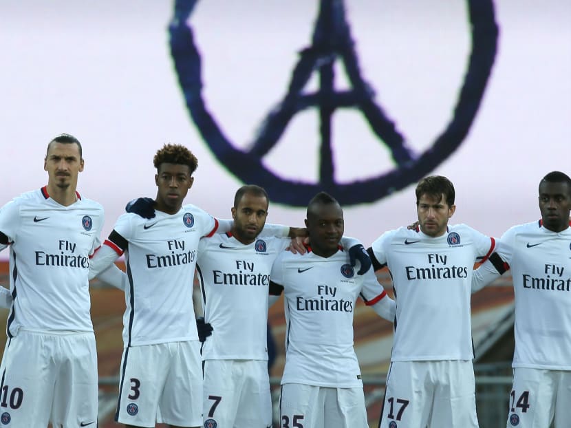 Paris Saint Germain's players observe a minute of silence in memory of the victims of the Paris attacks. Photo: AP