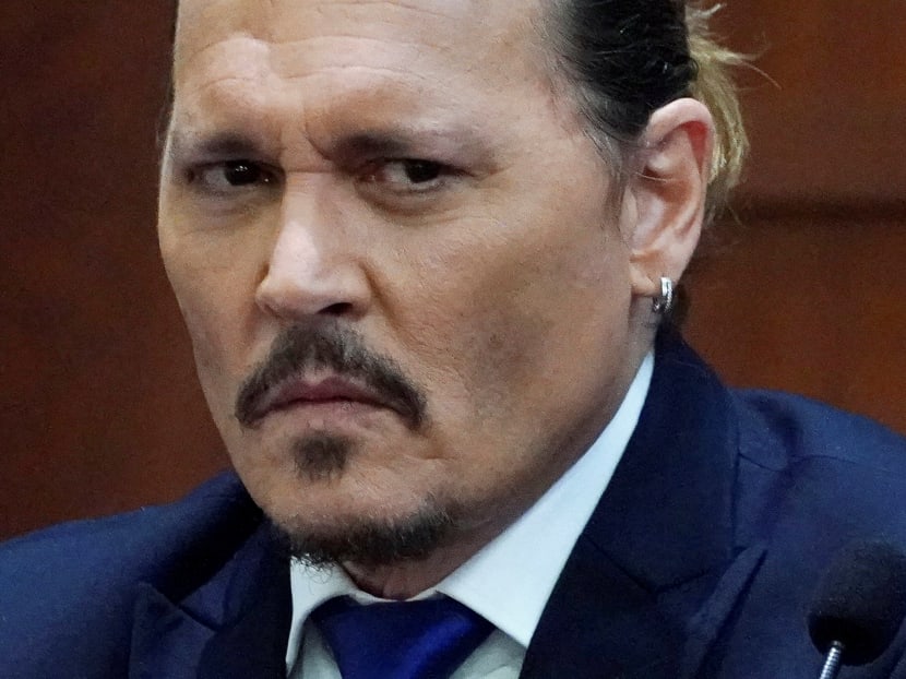 Actor Johnny Depp grimaces as he testifies during his defamation trial against ex-wife Amber Heard at the Fairfax County Circuit Courthouse in Fairfax, Virginia, on April 25, 2022.
