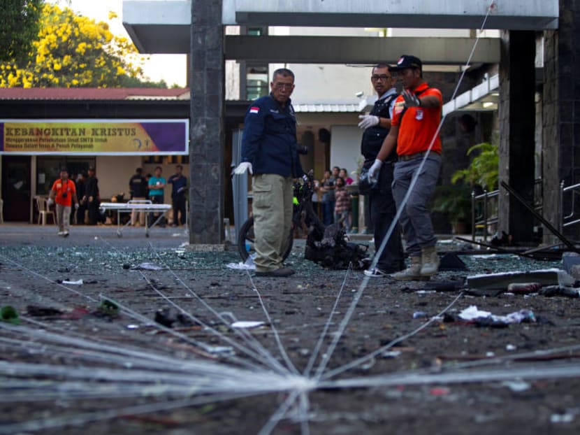 Police forensic team examine the scene of a bomb at a church in Surabaya on Sunday (May 13).