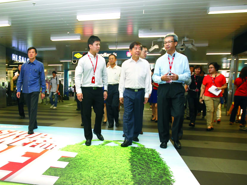 National Development Minister Khaw Boon Wan (centre) and SMRT Chief Executive and President Desmond Kuek at Woodlands MRT Station yesterday. Photo: Ernest Chua