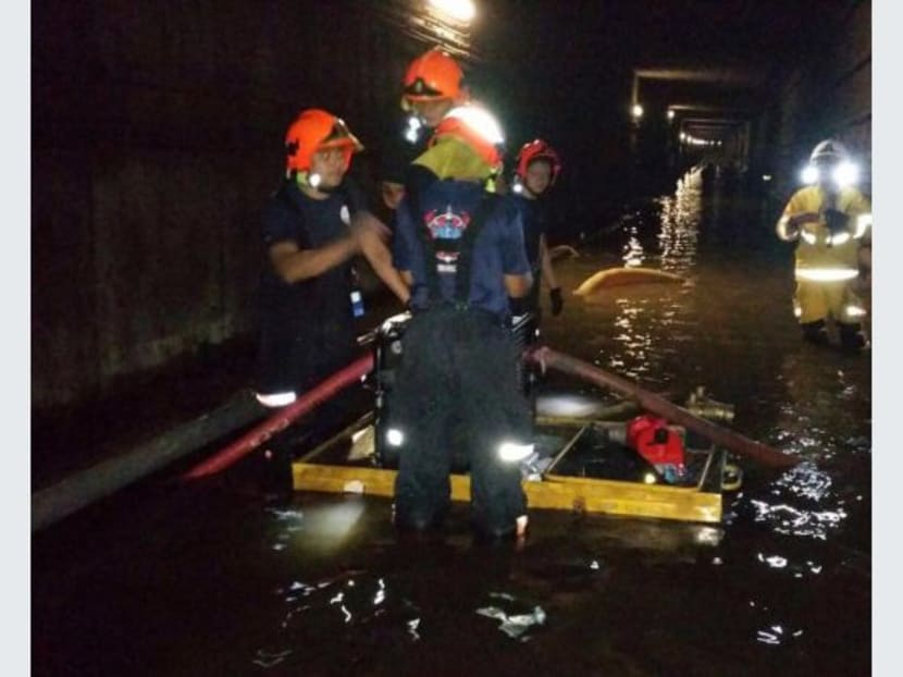 To prevent a repeat of the underground MRT tunnel flooding two weekends ago, which completely shut down train services along six stations on the North-South Line, rail operator SMRT has put in place several flood protection measures. Photo: SCDF