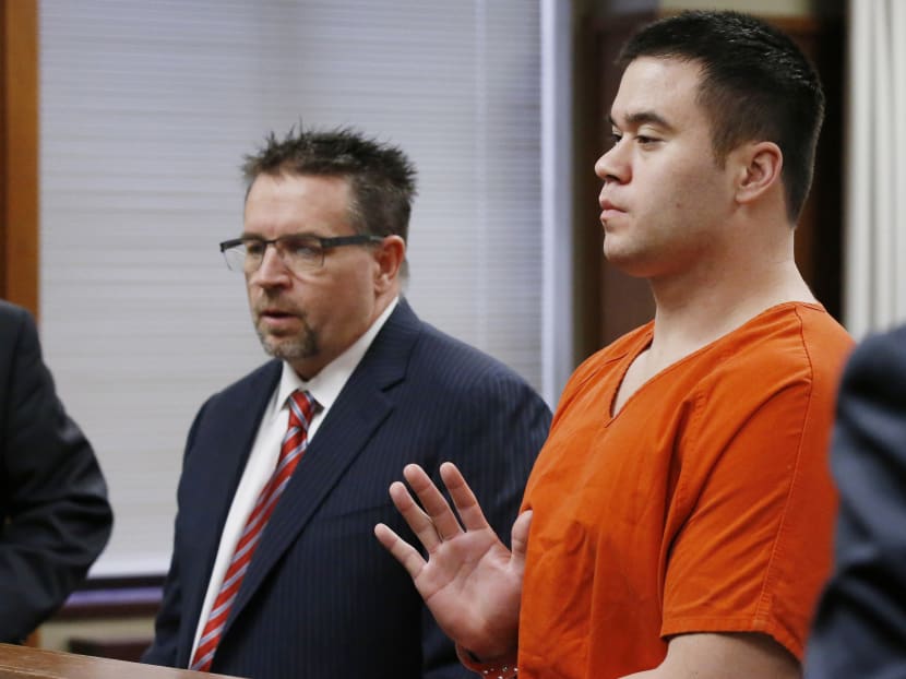 In handcuffs, Daniel Holtzclaw, right, raises his right hand as he is sworn in for his sentencing in Oklahoma City, on Jan 21, 2016. Photo: AP