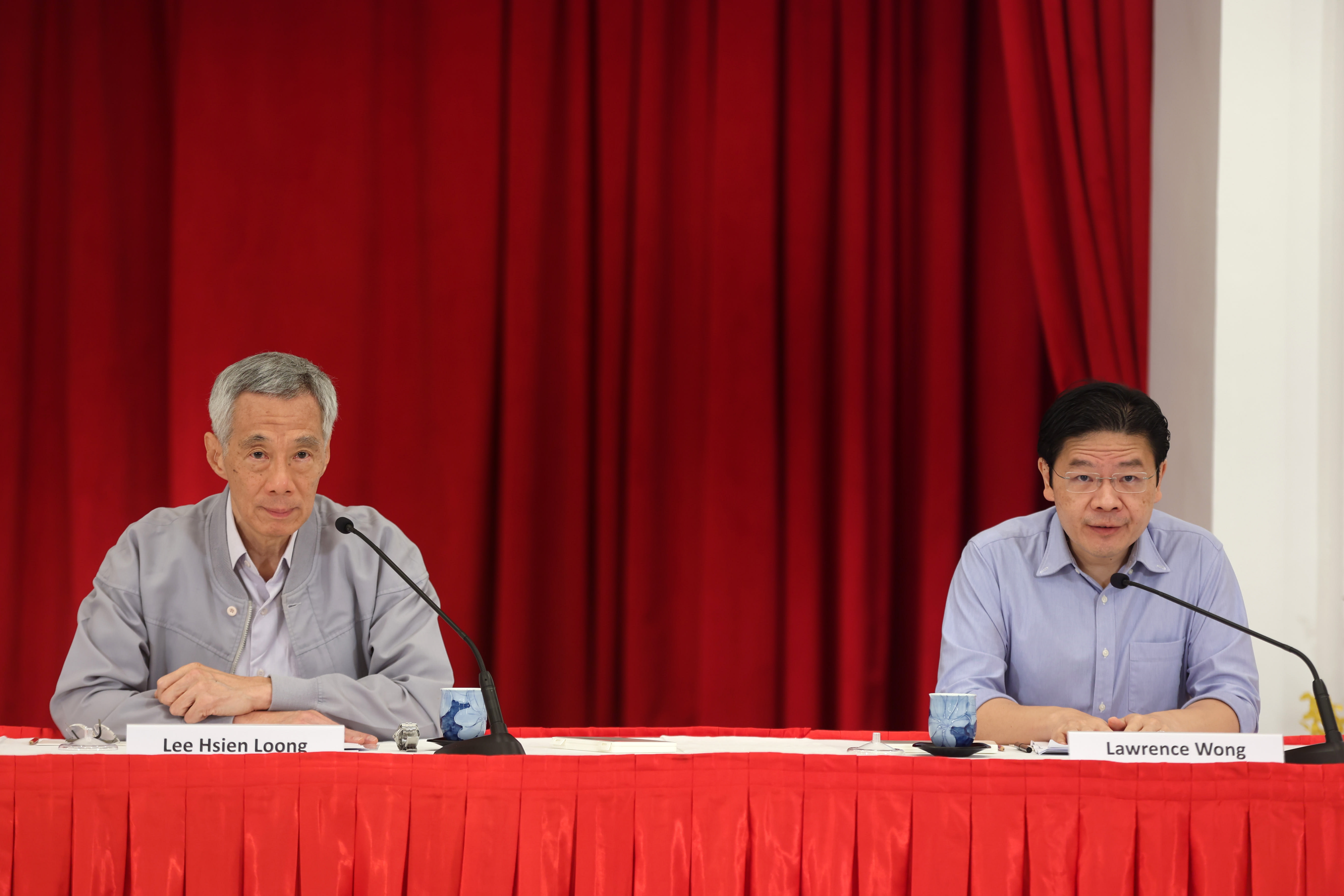 Prime Minister Lee Hsien Loong (left) and Finance Minister Lawrence Wong speaking at a press conference on leadership succession on April 16, 2022.