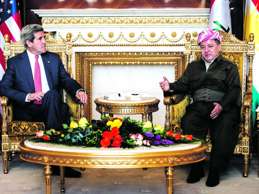Kurdish regional President Massoud Barzani (right) with US Secretary of State John Kerry at the presidential palace in Irbil, Iraq, yesterday. Mr Kerry arrived in Iraq’s Kurdish region in a US diplomatic drive aimed at preventing the country from splitting apart in the face of militants pushing towards Baghdad. PHOTO: AP