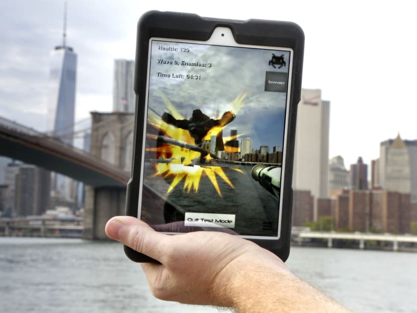 An example of what an Augmented Reality app video game would look like being played with the Epson Moverio BT-200 Smart Glasses, is displayed on a tablet from Brooklyn Bridge Park, Tuesday, Oct 7, 2014, in New York. Photo: AP